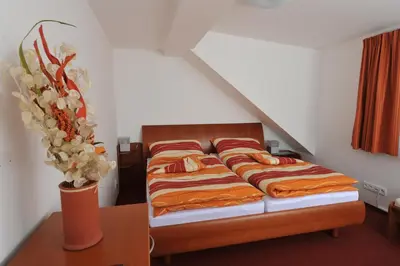 a bedroom with a bed and a vase of flowers at Habitat 16 in Prague