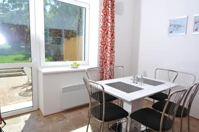 a dining room with a table and chairs and a window at Habitat 16 in Prague