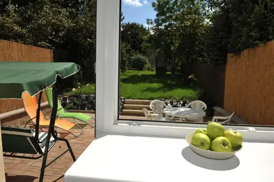 a bowl of apples on a table in front of a window at Habitat 16 in Prague