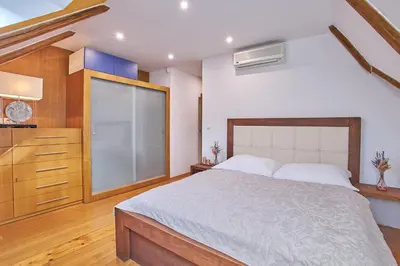 a bedroom with a large bed and a window at Žatecká - Terrace Residence in the Old Town in Prague