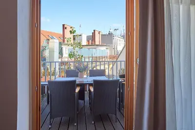 a balcony with a table and chairs on a balcony at Žatecká - Terrace Residence in the Old Town in Prague