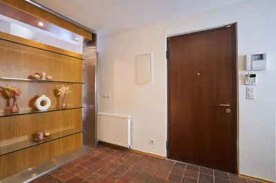 a hallway with a brown door and shelves at Žatecká - Terrace Residence in the Old Town in Prague