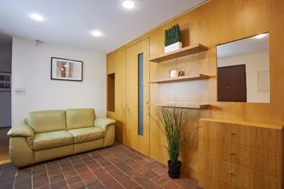 a living room with a couch and a mirror at Žatecká - Terrace Residence in the Old Town in Prague