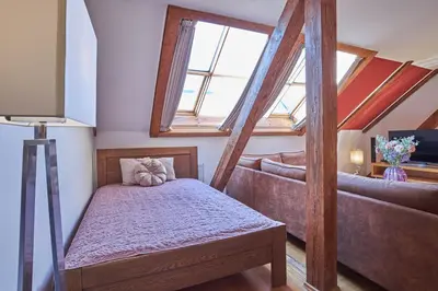 a small room with a bed and a couch at Žatecká - Terrace Residence in the Old Town in Prague