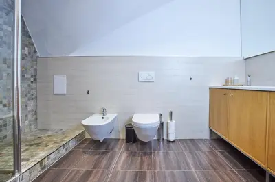 a bathroom with a tub and a toilet and a sink at Žatecká - Terrace Residence in the Old Town in Prague