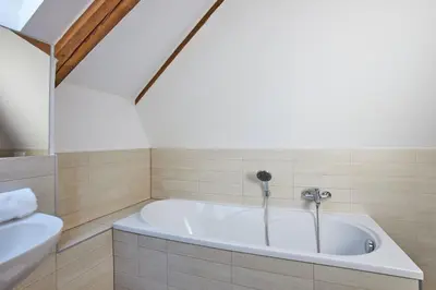 a bathroom with a tub and a sink at Žatecká - Terrace Residence in the Old Town in Prague