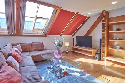 a living room with a couch and a tv at Žatecká - Terrace Residence in the Old Town in Prague