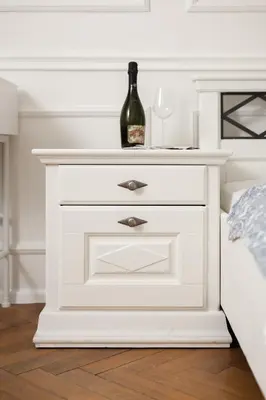 a white bedside table with a bottle of wine on it at Airstay Prague : DeLuxe Apartment Old town in Prague