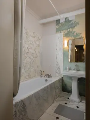 a bathroom with a tub and a sink at Airstay Prague : DeLuxe Apartment Old town in Prague