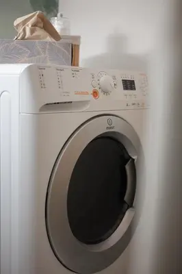 a white washing machine with its door open at Airstay Prague : DeLuxe Apartment Old town in Prague