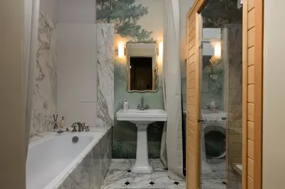 a bathroom with a tub and a sink and a bath tub at Airstay Prague : DeLuxe Apartment Old town in Prague