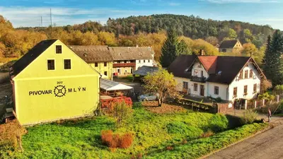 an aerial view of a village with a yellow building at Pivovar Mlýn in Štětí