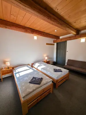 a room with two beds and a couch in it at Pivovar Mlýn in Štětí