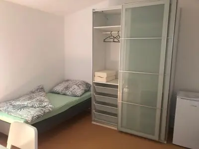 a small bedroom with a bed and a closet at Klidné místo v Měsíčním údolí Poříčí nad Sázavou in Poříčí nad Sázavou