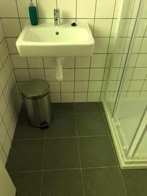 a bathroom with a sink and a trash can at Klidné místo v Měsíčním údolí Poříčí nad Sázavou in Poříčí nad Sázavou