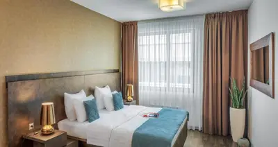 a hotel room with a large bed and a window at VN3 Terraces Suites by Adrez in Prague