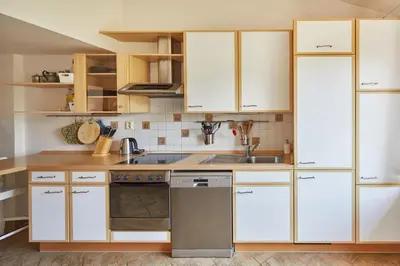 a bedroom with a bed and a skylight at Prague Days - Open-plan Duplex with Corner Bath and Netflix in Vinohrady in Prague