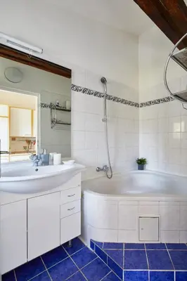 a kitchen with a table and chairs and a sink at Prague Days - Open-plan Duplex with Corner Bath and Netflix in Vinohrady in Prague