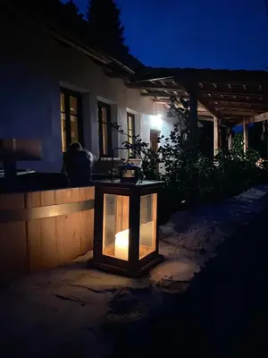 a lantern in front of a house at night at Apartmány pod Kozákem in Velké Popovice