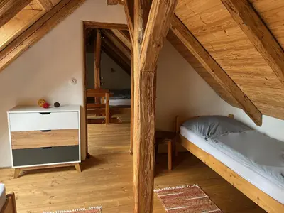a room with two bunk beds in a attic at Apartmány pod Kozákem in Velké Popovice