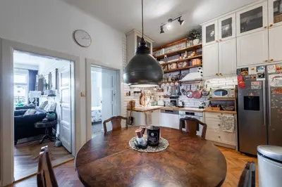 a kitchen with a wooden table and a dining room at Victoria Design Stays - Premium Apartment Ohrada in Prague