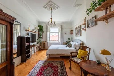 a bedroom with a bed and a table at Victoria Design Stays - Premium Apartment Ohrada in Prague