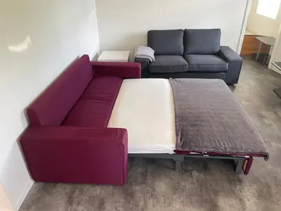 a living room with a bed and a couch at River wellness in Jince