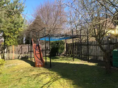 a batting cage in a yard next to a fence at Apartmány Jevany in Jevany