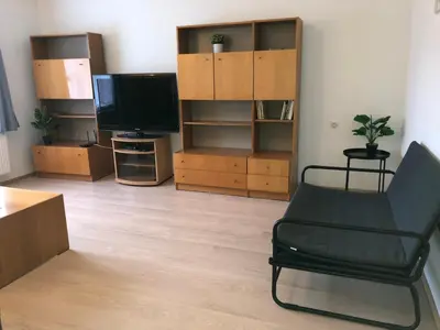 a living room with a chair and a television at Apartmány Jevany in Jevany