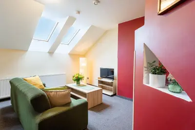a living room with a couch and a tv at Hotel Libero in Prague