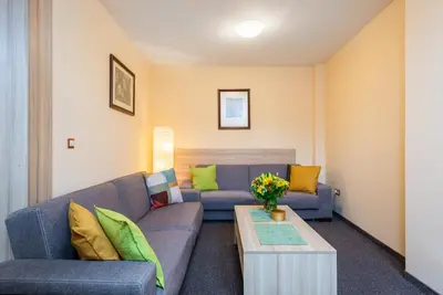 a living room with a couch and a table at Hotel Libero in Prague