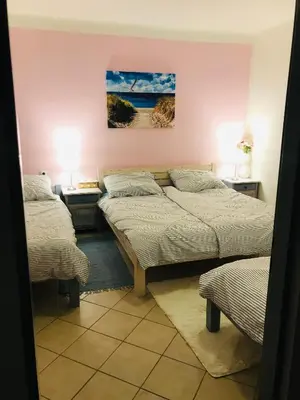 two beds in a room with two tables and two lamps at Apartmán U ŘEKY in Srbsko