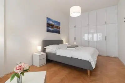 a bedroom with a bed and a vase of flowers at The BEST LOCATION in Prague, Charles Bridge & Old Town Square in Prague
