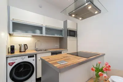 a kitchen with a washing machine and a sink at The BEST LOCATION in Prague, Charles Bridge & Old Town Square in Prague