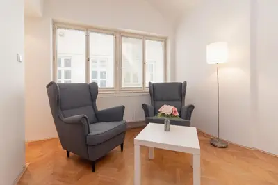 two chairs and a table in a living room at The BEST LOCATION in Prague, Charles Bridge & Old Town Square in Prague