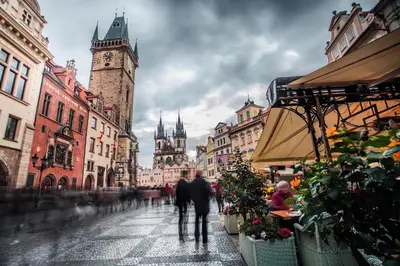 a group of people walking down a city street at The BEST LOCATION in Prague, Charles Bridge & Old Town Square in Prague
