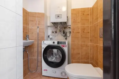 a bathroom with a washing machine and a toilet at The BEST LOCATION in Prague, Charles Bridge & Old Town Square in Prague