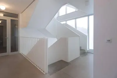 a white staircase in a house with a window at Bright studio, 10min to the Centre, free Parking in Prague