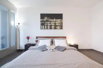 a bedroom with a large bed with two pillows at Bright studio, 10min to the Centre, free Parking in Prague