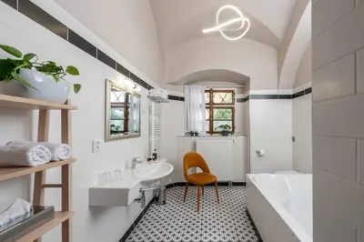 a white bathroom with a sink and a mirror at Zámecký hotel & Wellness in Poděbrady
