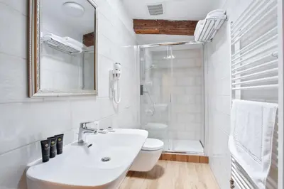 a bathroom with two sinks and a large tub at Zámecký hotel & Wellness in Poděbrady