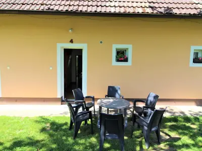 a table and chairs in front of a house at Apartment Rabyně-2 by Interhome in Rabyně