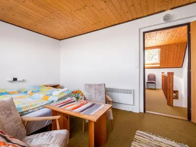 a living room with a bed and a table at Apartment Rabyně-2 by Interhome in Rabyně