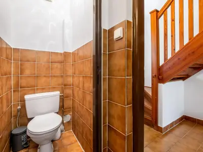 a bathroom with a toilet and a staircase at Apartment Rabyně-2 by Interhome in Rabyně