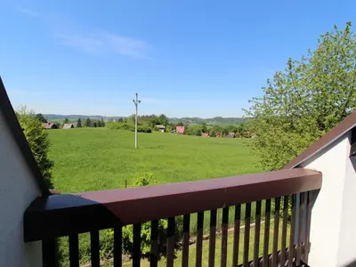 a balcony with a view of a green field at Apartment Rabyně-2 by Interhome in Rabyně