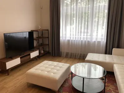 a living room with a couch and a tv at Dobré časy Apartment in Poděbrady