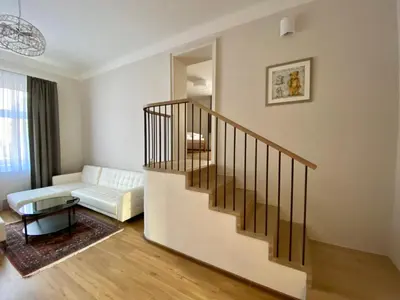 a living room with a staircase and a couch at Dobré časy Apartment in Poděbrady