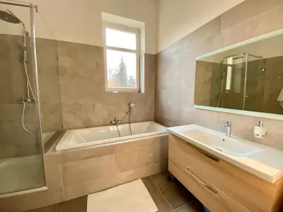 a bathroom with a tub and a sink and a shower at Dobré časy Apartment in Poděbrady
