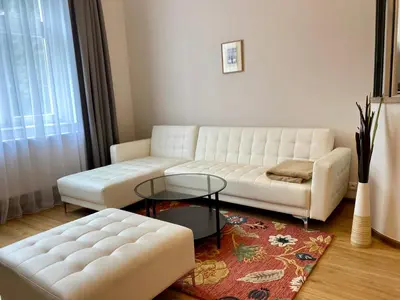 a living room with a white couch and a table at Dobré časy Apartment in Poděbrady