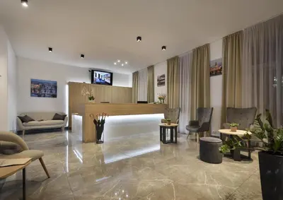 a living room with a lobby with chairs and a table at Prague Season Hotel in Prague